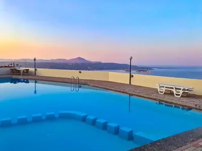 a large swimming pool with a view of the ocean at Kalithea Studio Aptera in Megála Khoráfia
