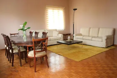 a living room with a table and a couch at Spacious townhouse close to Chania center in Chania Town