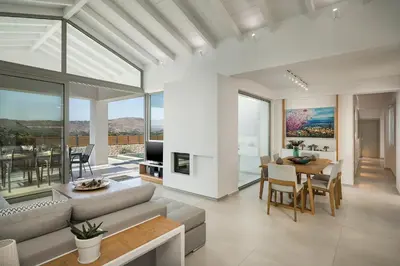a living room with a couch and a table at Villa White Harmony in Khámbatha