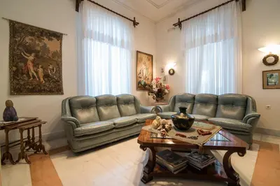 a living room with leather couches and a table at Creta Elena in Chania Town
