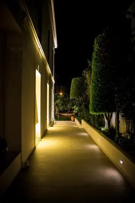 a hallway leading to a building at night at Creta Elena in Chania Town