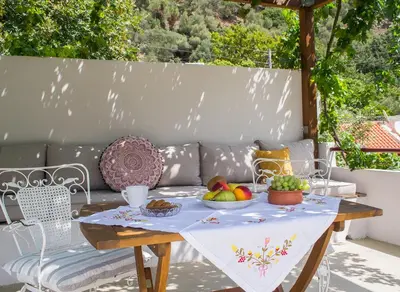 a table with fruit on it on a patio at Feneri- cozy Apartment 20' from Elafonisi beach in Elafonisi