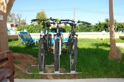 two bikes parked next to each other in the grass at Cormoranos Apartments Rooms Eco Green in Kissamos