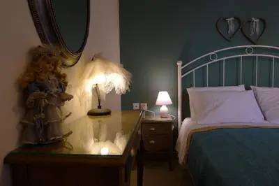 a bedroom with a bed and a table with a mirror at Diamant's Place with Treehouse Garden in Kounoupidhianá
