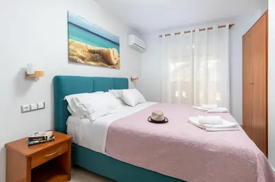 a bedroom with a bed with a hat on it at Sun Beach Apartments in Kato Daratso