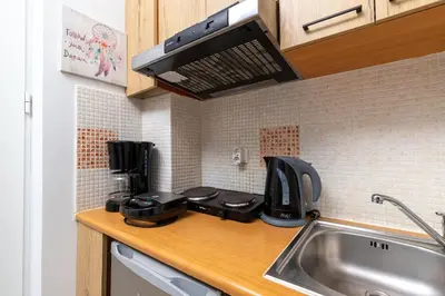 a kitchen counter with a sink and a coffee maker at Sun Beach Apartments in Kato Daratso