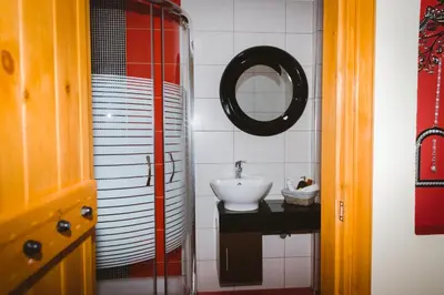 a bathroom with a sink and a mirror at Aristos Apartments & Suites in Stalos