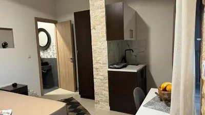 a kitchen with a sink and a counter top at Aristos Apartments & Suites in Stalos