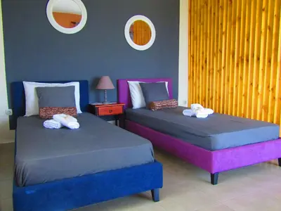 two beds sitting next to each other in a room at Aristos Apartments & Suites in Stalos