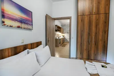 a bedroom with a bed and a painting on the wall at Stelios & Stavros Apartment in Kissamos