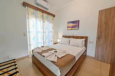 a bedroom with a bed with towels on it at Stelios & Stavros Apartment in Kissamos