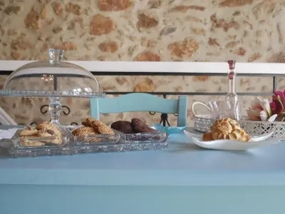 a table with a plate of pastries and a plate of cookies at Agalide in Kissamos