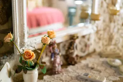 a vase with flowers in front of a mirror at Agalide in Kissamos