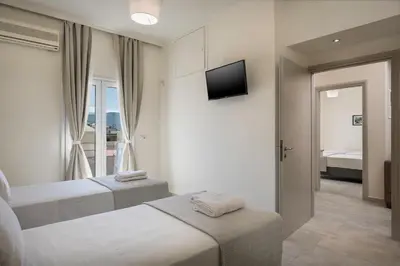 a hotel room with two beds and a mirror at Casa Di Xenia in Chania Town