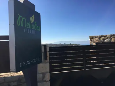 a sign for a wellness clinic in front of a fence at Meliades Villas in Agia Marina Nea Kydonias