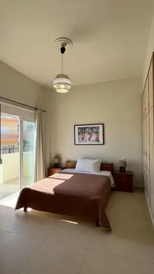 a bedroom with a large bed and a window at Lily of Crete 1 - Sea & Beach front Apartment in Kalamaki Chanion