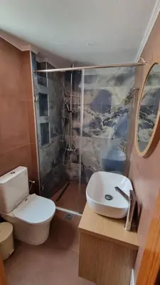 a bathroom with a toilet and a sink and a shower at Villa Mimagia Apartments in Palaiochóra