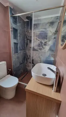 a bathroom with a sink and a toilet at Villa Mimagia Apartments in Palaiochóra