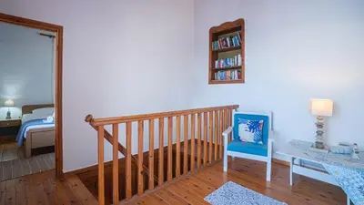 a room with a crib and a bedroom with a bed at Villa Niki in Loutro