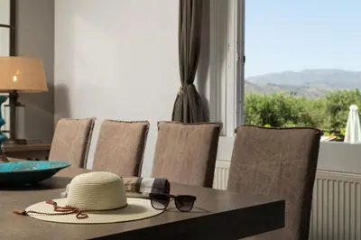 a hat and sunglasses sitting on a table with a window at Villa Tranquilla in Kolymvari