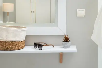 a shelf with glasses and a basket and a mirror at Villa Tranquilla in Kolymvari