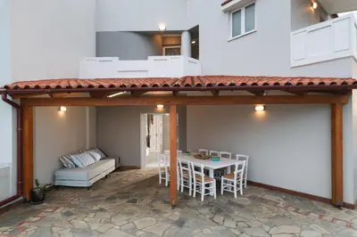 a patio with a table and chairs and a couch at Villa Tranquilla in Kolymvari