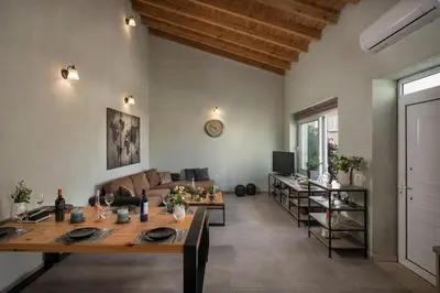 a living room with a table and a couch at Villa Roxanne in Galatás