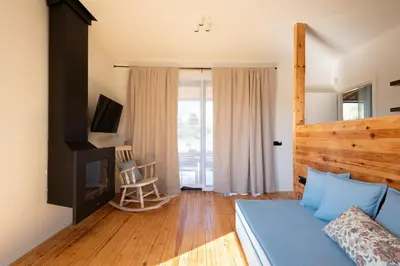 a bedroom with a bed and a tv and a chair at MV Living - Retreat in Daratso