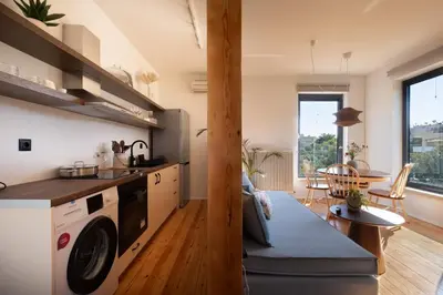 a kitchen with a washer and dryer in a room at MV Living - Retreat in Daratso