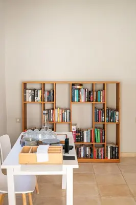 a white table in front of a book shelf at The Mini Beach Hotel in Stalos