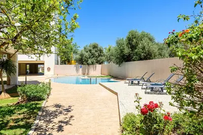a backyard with a swimming pool and a fence at Apartment A80 in Chania Town