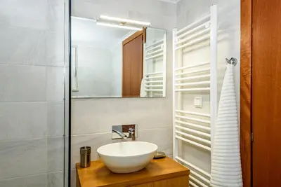 a bathroom with a white sink and a mirror at Apartment A80 in Chania Town