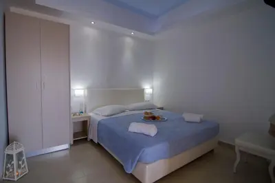 a bedroom with a bed with a plate of food on it at Frida Apartments in Chania Town