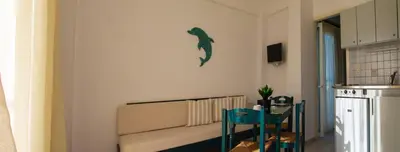a living room with a couch and a fish on the wall at Frida Apartments in Chania Town