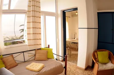 a living room with a couch and a window at Akrotiri Hotel in Chania Town