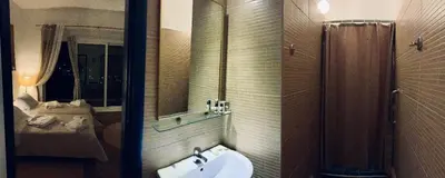 a bathroom with a sink and a shower at Akrotiri Hotel in Chania Town