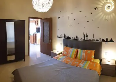 a bedroom with a bed and a chandelier at Enjoy Sunset in Palaiochóra