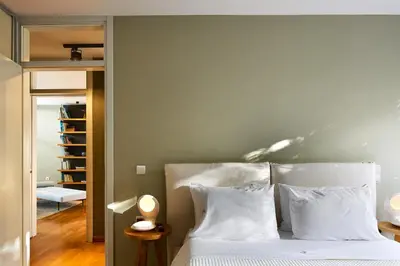 a bedroom with a bed with white sheets and pillows at Villa 7 in Perivólia