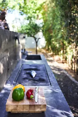 a cutting board with vegetables on a table at Villa 7 in Perivólia