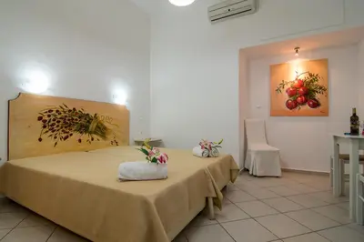 a hotel room with two beds and a table at Manto Studios in Palaiochóra