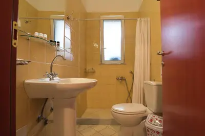 a bathroom with a sink and a toilet at Manto Studios in Palaiochóra