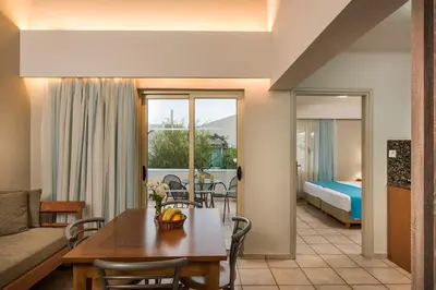 a living room with a couch and a table at Elotis Suites in Agia Marina Nea Kydonias