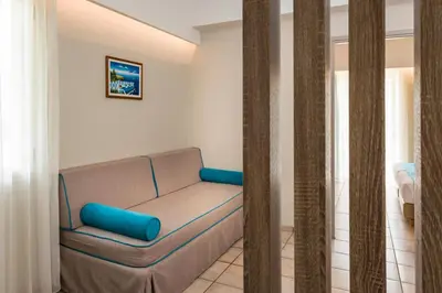 a living room with a couch in a room at Elotis Suites in Agia Marina Nea Kydonias