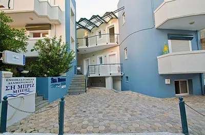 a blue building with stairs and a sign on it at Sea Breeze in Kalamaki Chanion