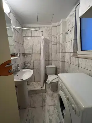 a white bathroom with a sink and a toilet at Sea Breeze in Kalamaki Chanion