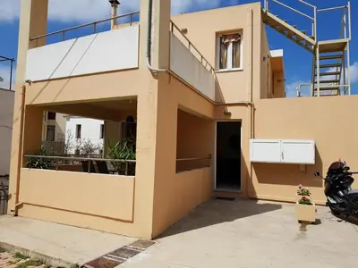 a house with a balcony and a staircase on it at Ilia's Apt in Chania in Chania Town