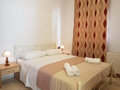 a bedroom with a bed with two towels on it at Ilia's Apt in Chania in Chania Town