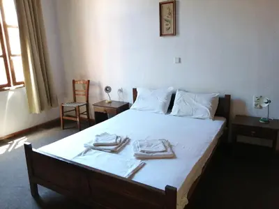 a bedroom with a bed with two towels on it at Lito Rooms in Chania Town