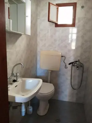 a bathroom with a toilet and a sink at Lito Rooms in Chania Town
