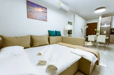 a bedroom with a bed and a living room at Raimonda's House in Chania Town